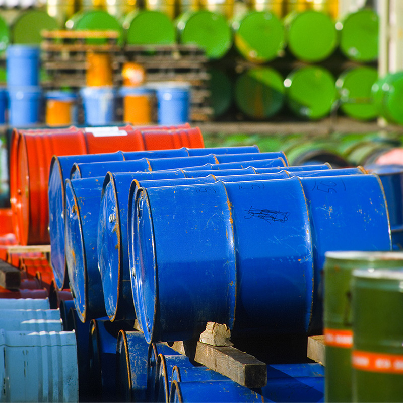 a bunch of blue barrels are stacked on top of each other.
