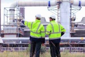 Engineers,Workers,With,Tablet,In,A,Refinery,-,Oil,Processing